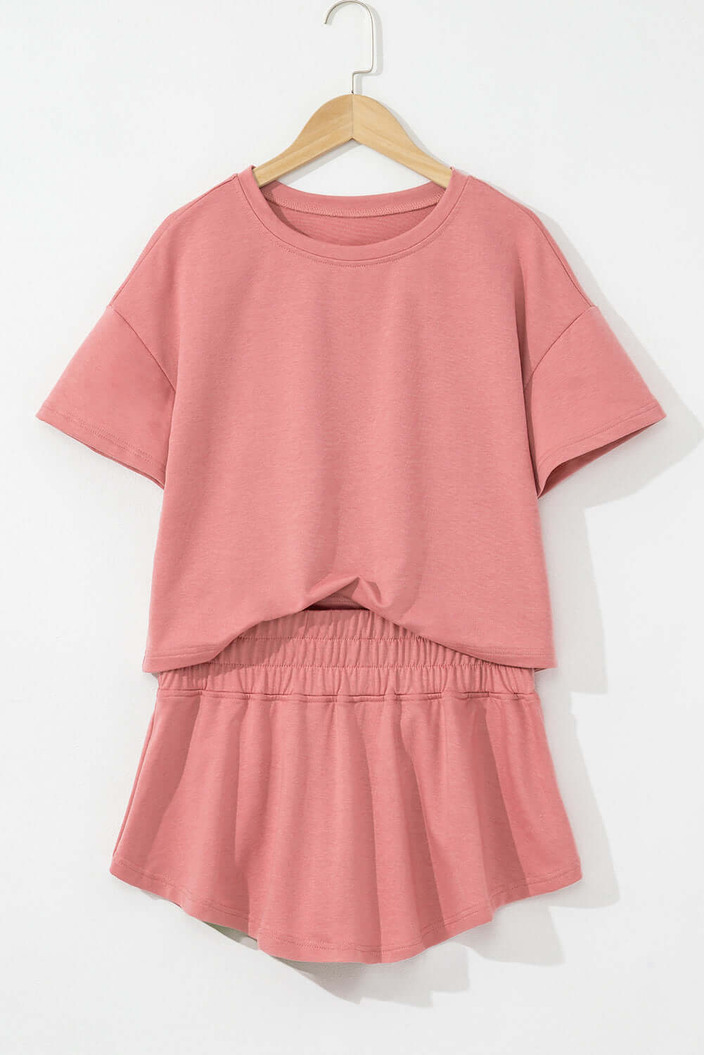 Blossom Cropped Tee and Ruffle High Waist Skort Set in soft pink, showcasing casual elegance and feminine ruffle details.