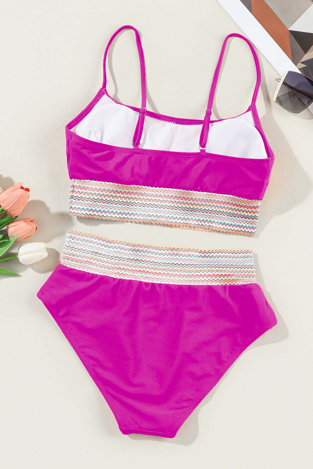 Pink high waist bikini set with spaghetti straps and striped patchwork design, perfect for the beach and poolside.