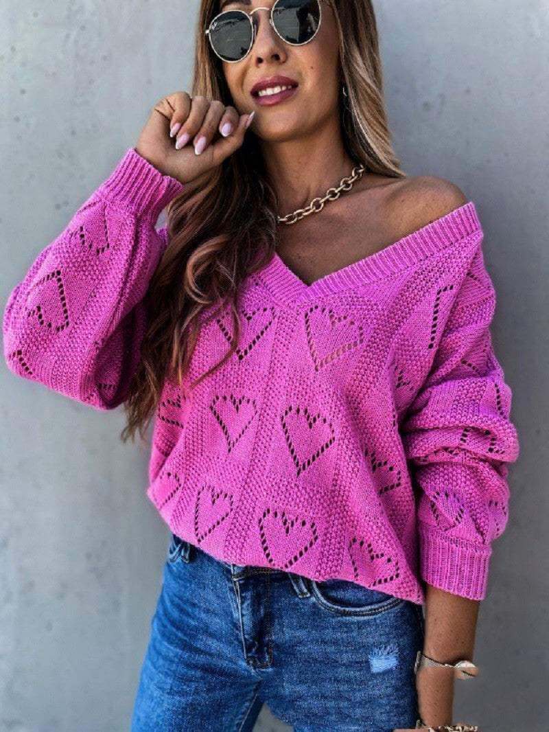 Pink hollow heart knit women's sweater with off-shoulder design.