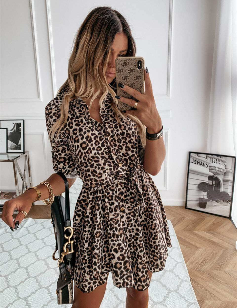 Leopard print short vintage dress for women, styled with a casual belt and half sleeves, displayed in a modern setting.