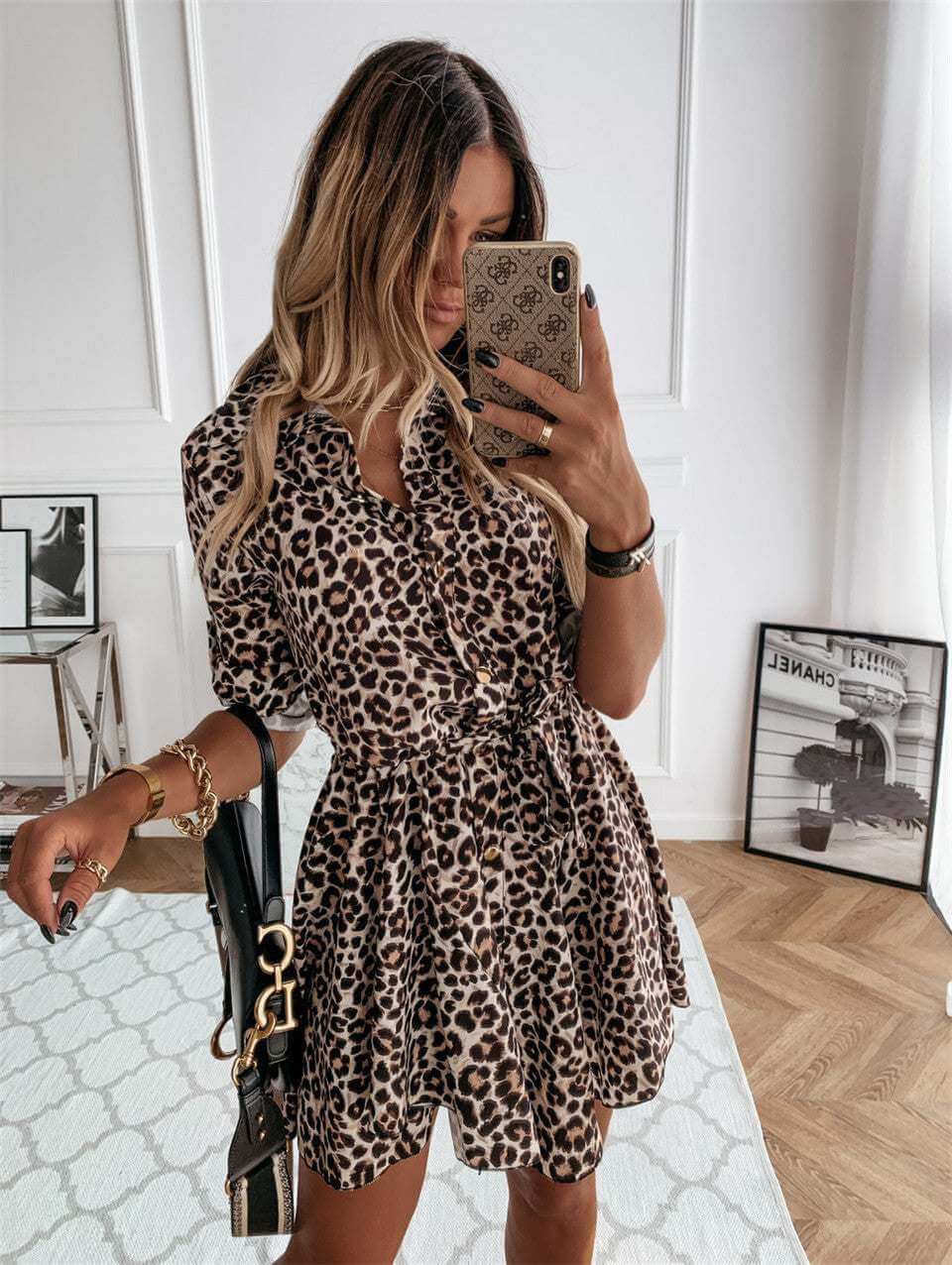 Leopard print short vintage dress for women, styled with a casual belt and half sleeves, displayed in a modern setting.