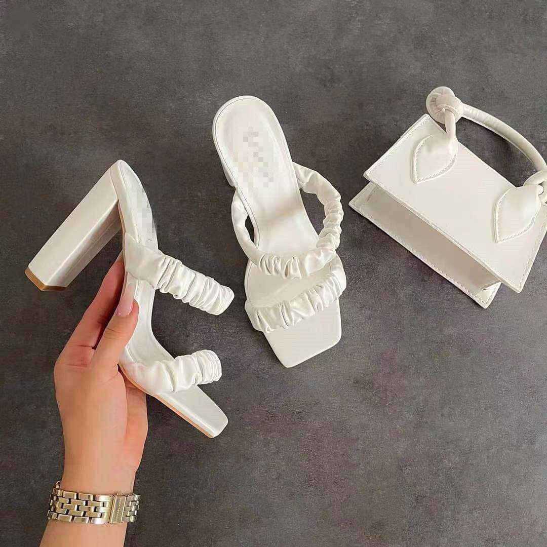 White PU high heel sandals with round toe and stylish design.