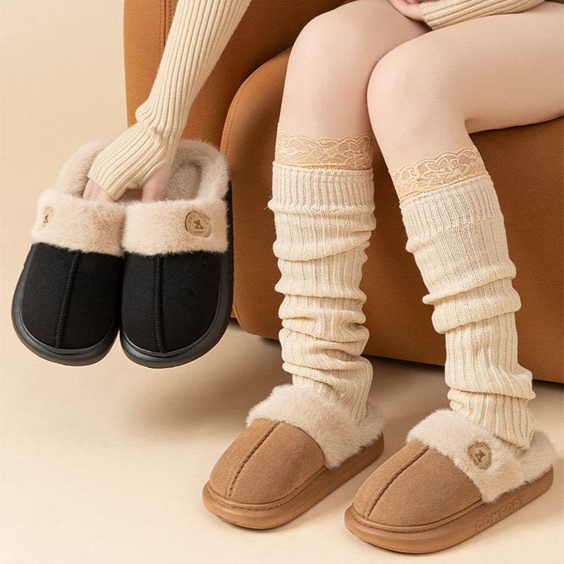 Plush winter slippers for women and men with thick fleece lining and PVC sole.