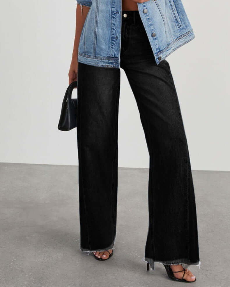 Loose casual straight-leg wide leg mop pants for women in black denim, styled with a blue denim jacket and heeled sandals.