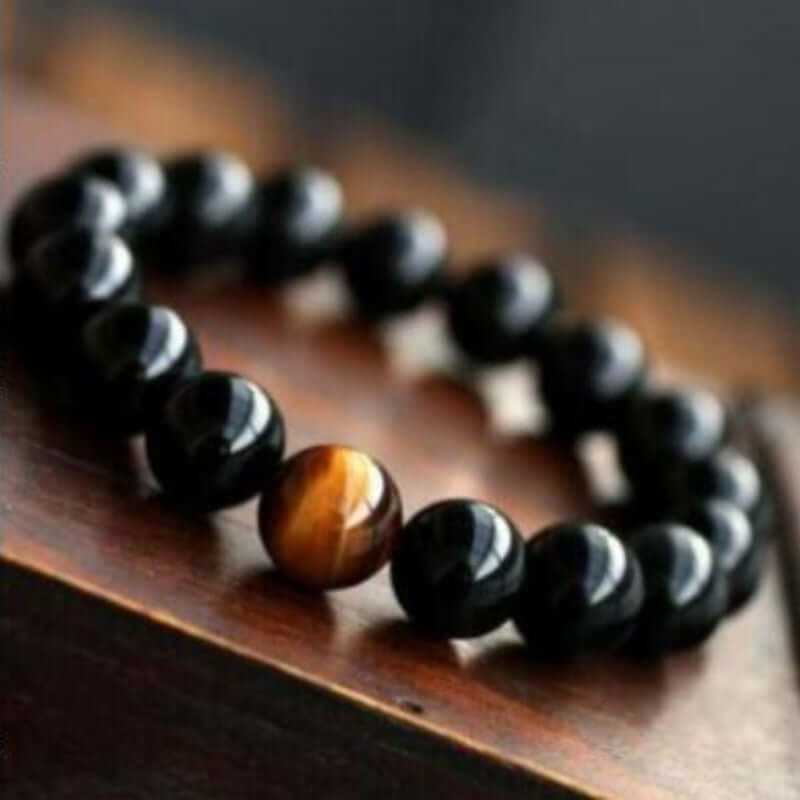 Natural black onyx bracelet with tiger eye stone beads, trendy fashion accessory.