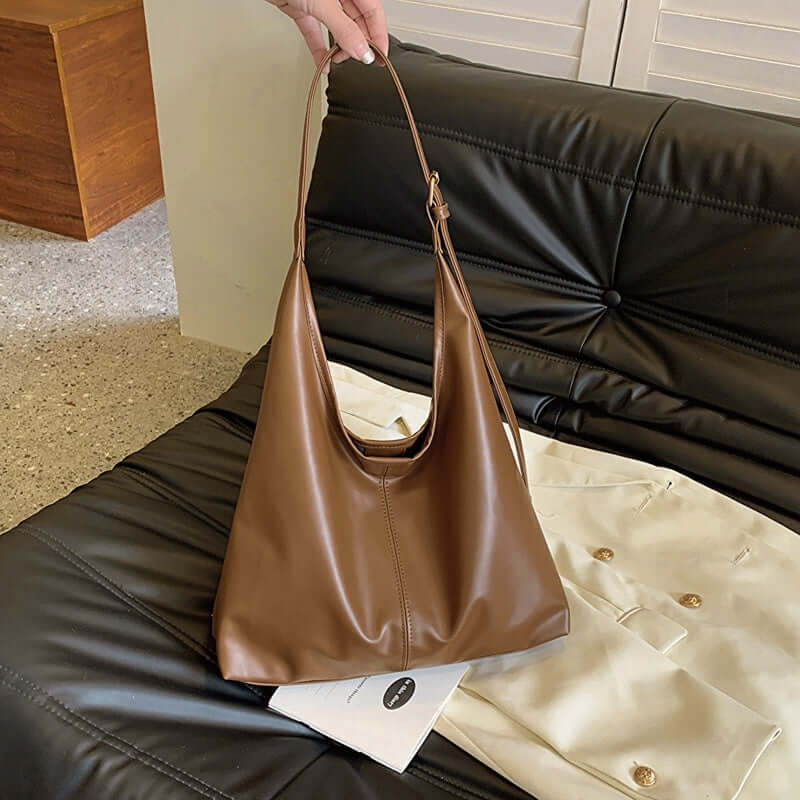 Large brown synthetic leather tote bag with single shoulder strap.