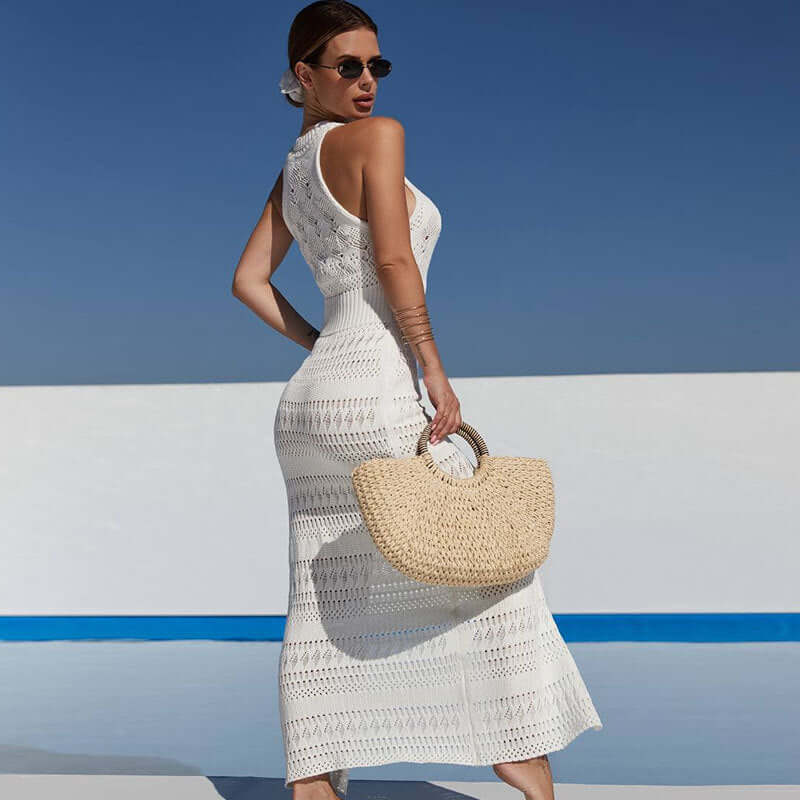 White hollow sleeveless overalls for beachwear, styled with a rattan bag and sunglasses against a sunny backdrop.