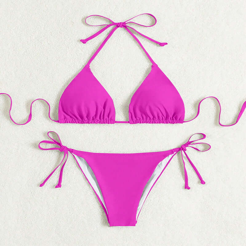 Women's pink tied halter bikini swimsuit on display, solid color, sexy style.