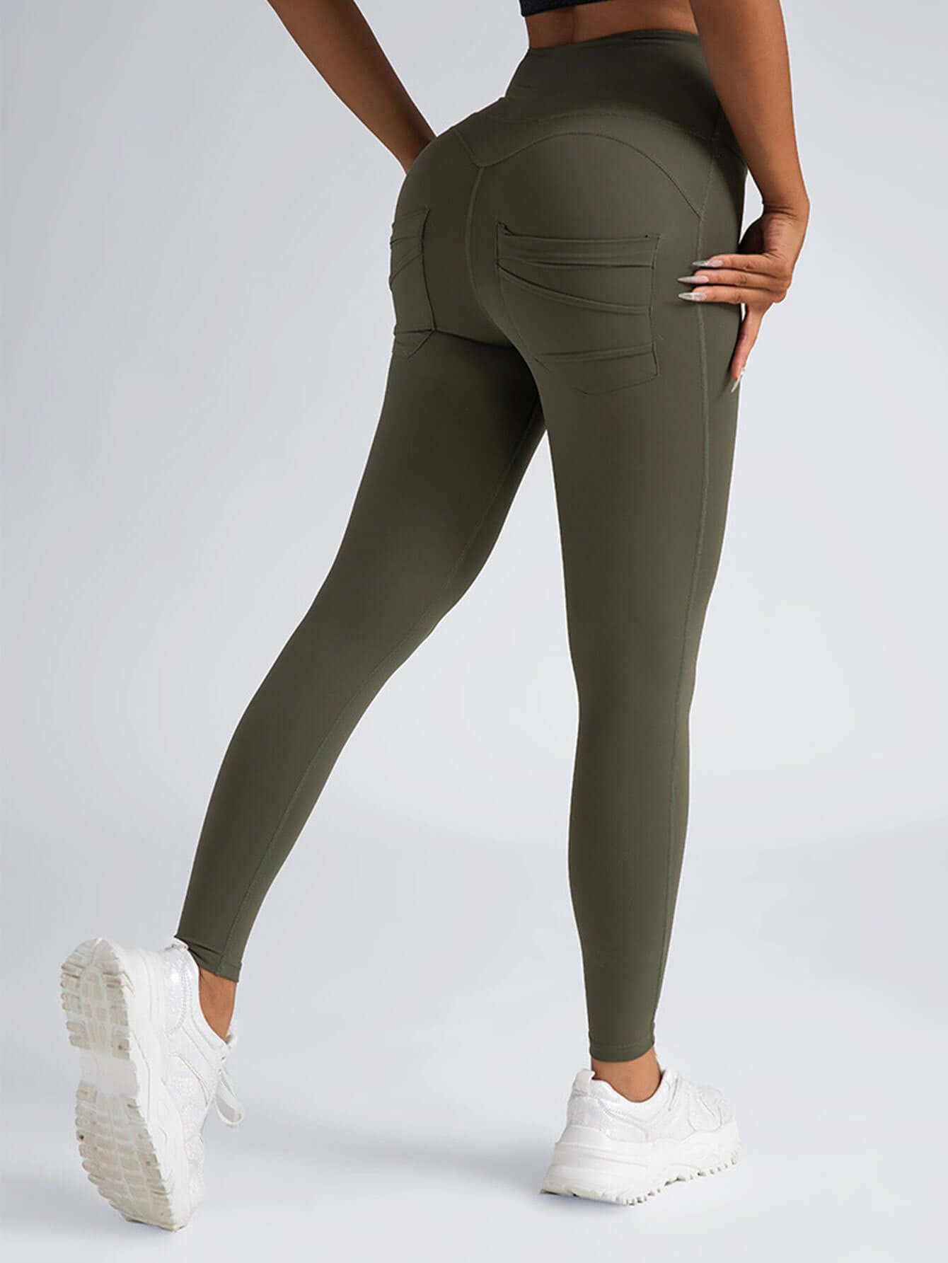 Womens high-waisted 4-way stretch yoga leggings in olive green with pockets, perfect for workouts and casual wear.