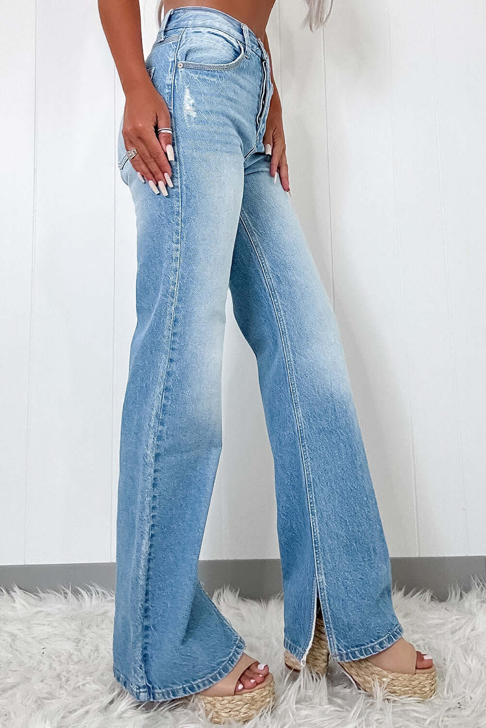 Model showcasing Myosotis Ripped High Rise Slit Jeans in light wash, highlighting vintage charm and flattering fit.