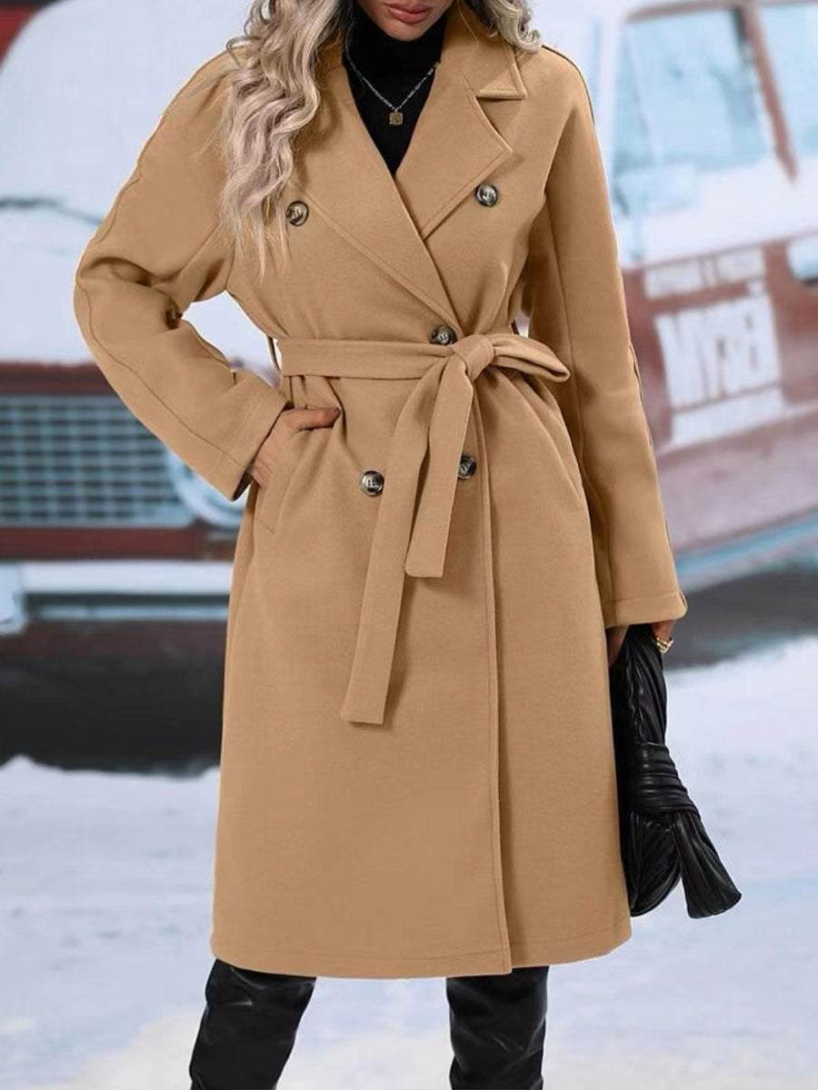 Women's long khaki trench coat with double-breasted design and belt, winter fashion.