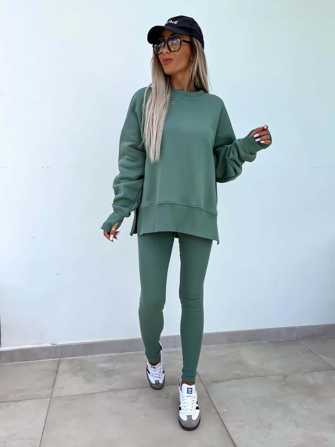 Women's casual loose long sleeve crew neck split top and tight trousers in green.