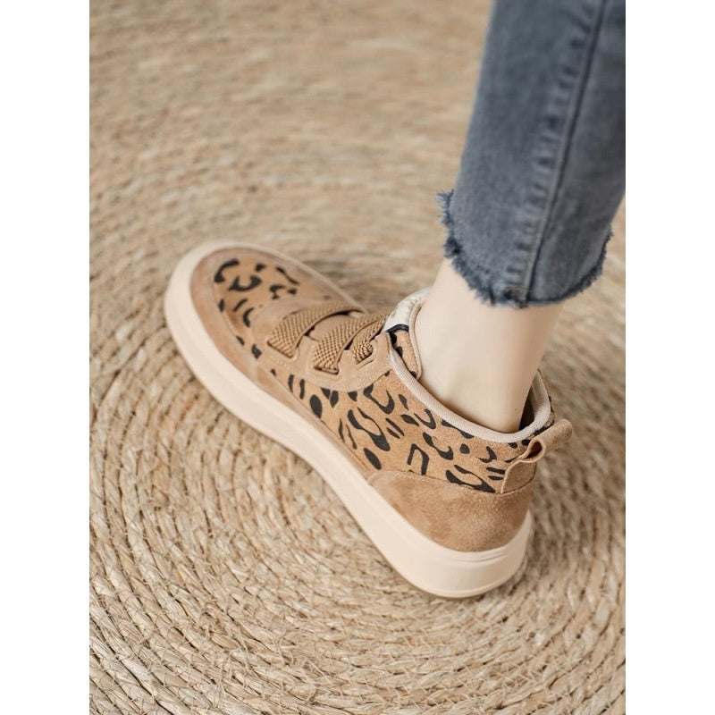 Leopard print high-top suede boots with rubber sole and mid heel.