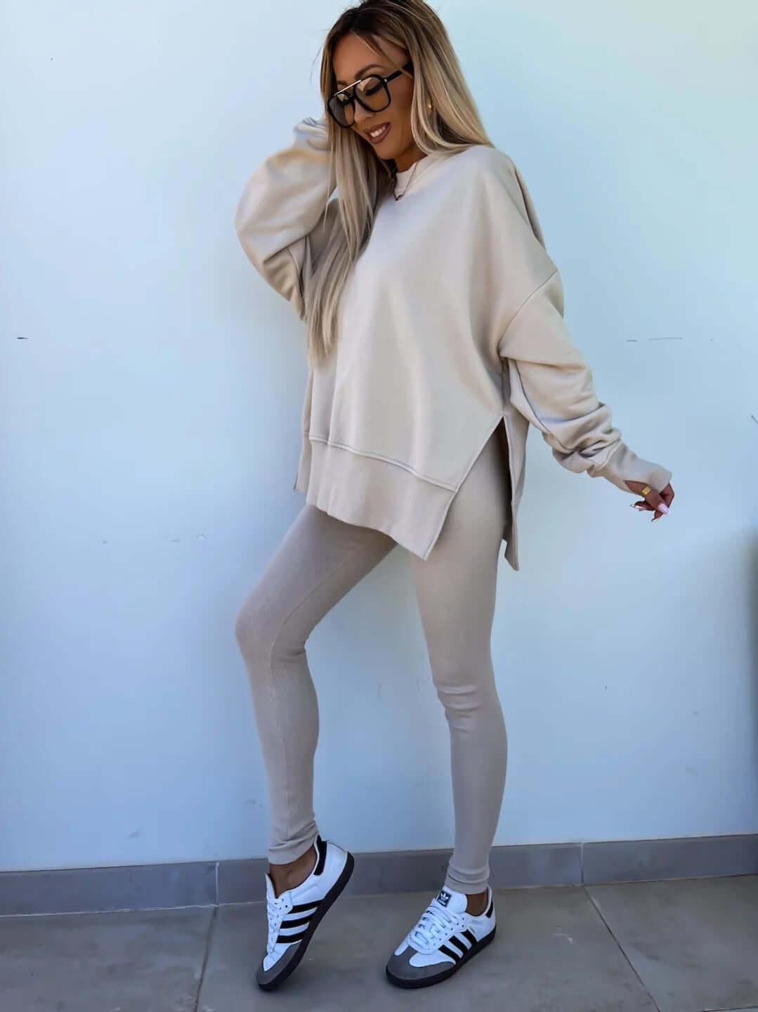 Women's casual loose long sleeve crew neck split top with tight trousers in apricot.