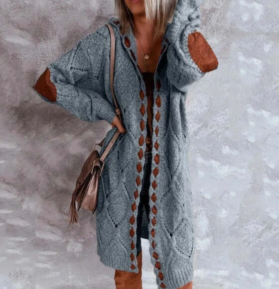 Woman wearing a grey and brown knit sweater cardigan with diamond pattern.