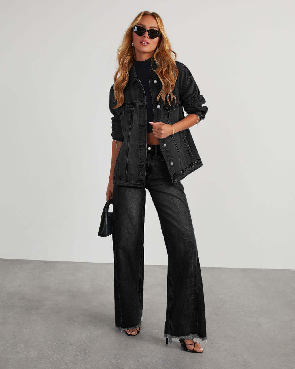 Loose casual straight-leg wide leg mop pants for women in black denim with jacket.