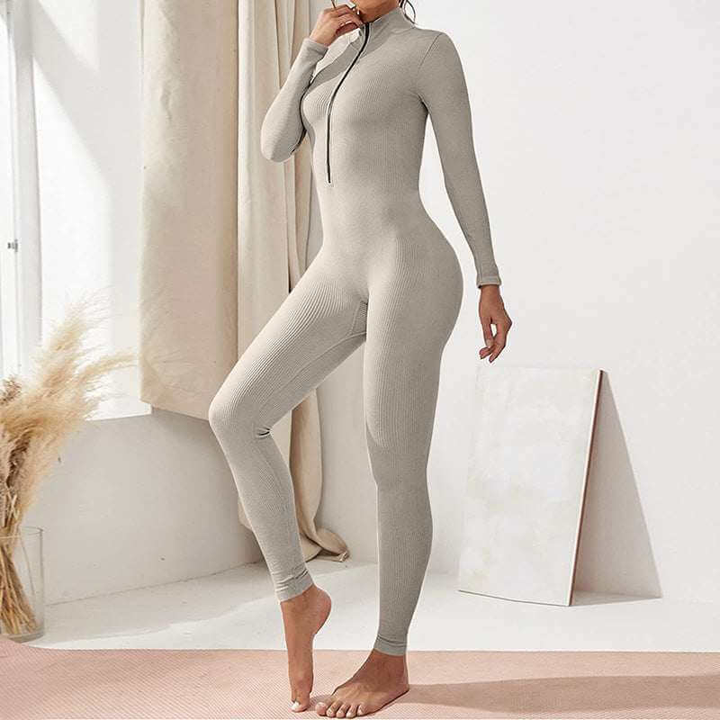 Seamless long sleeve yoga bodysuit in beige with zipper detail for fitness trends.