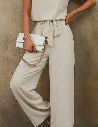 Women solid color sleeveless top with notch neckline and belted long pants set.