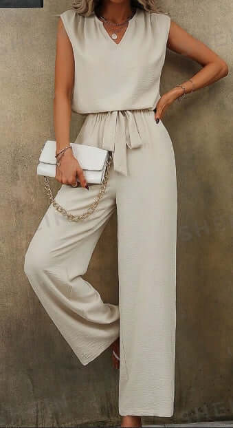 Women solid color sleeveless top with notch neckline and belted long pants set.