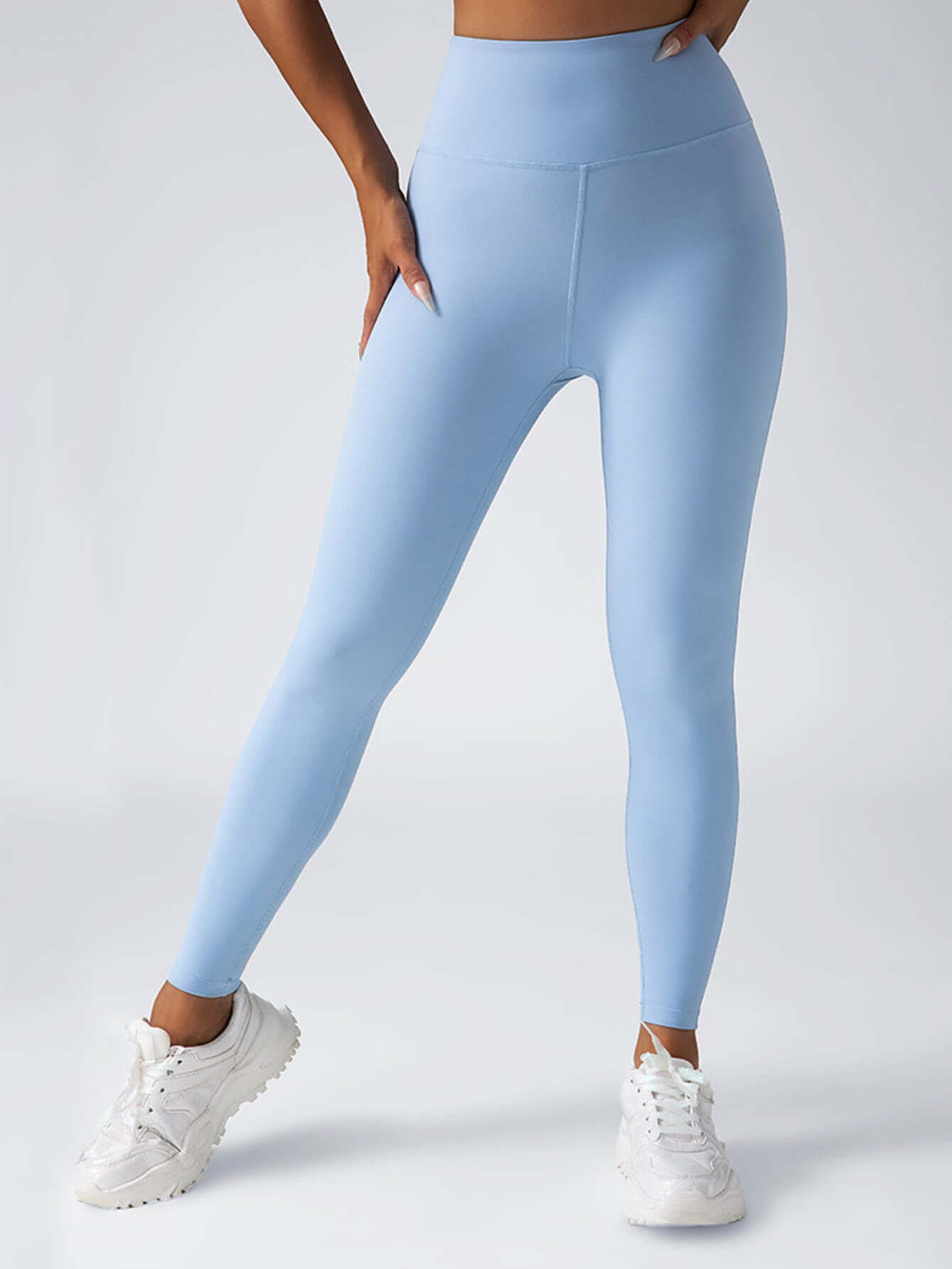 Light blue high waisted women's yoga leggings with tummy control, ideal for workouts and casual wear.