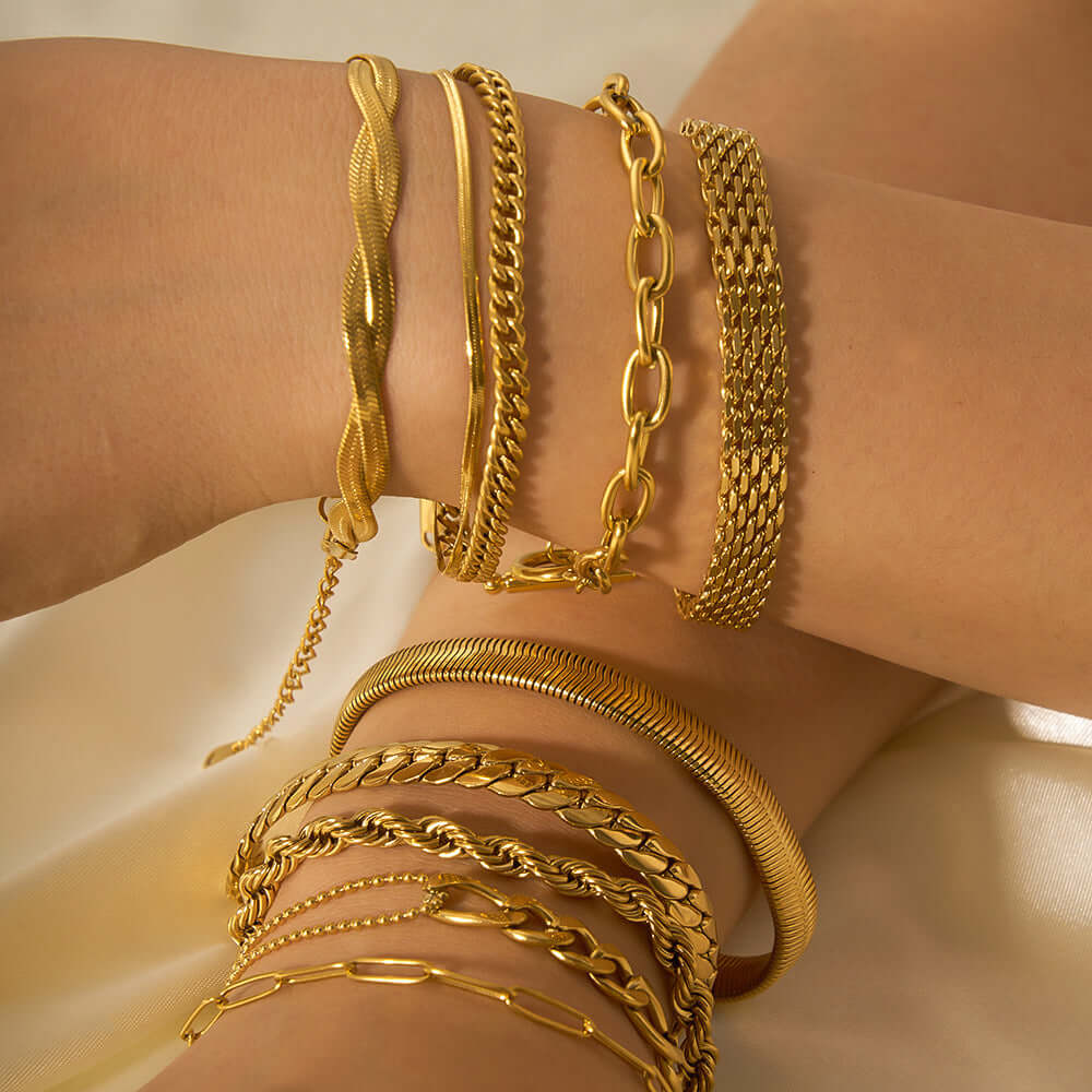 Stainless steel ornament bracelets in gold finish on a woman's wrist, showcasing geometric designs and elegant style.