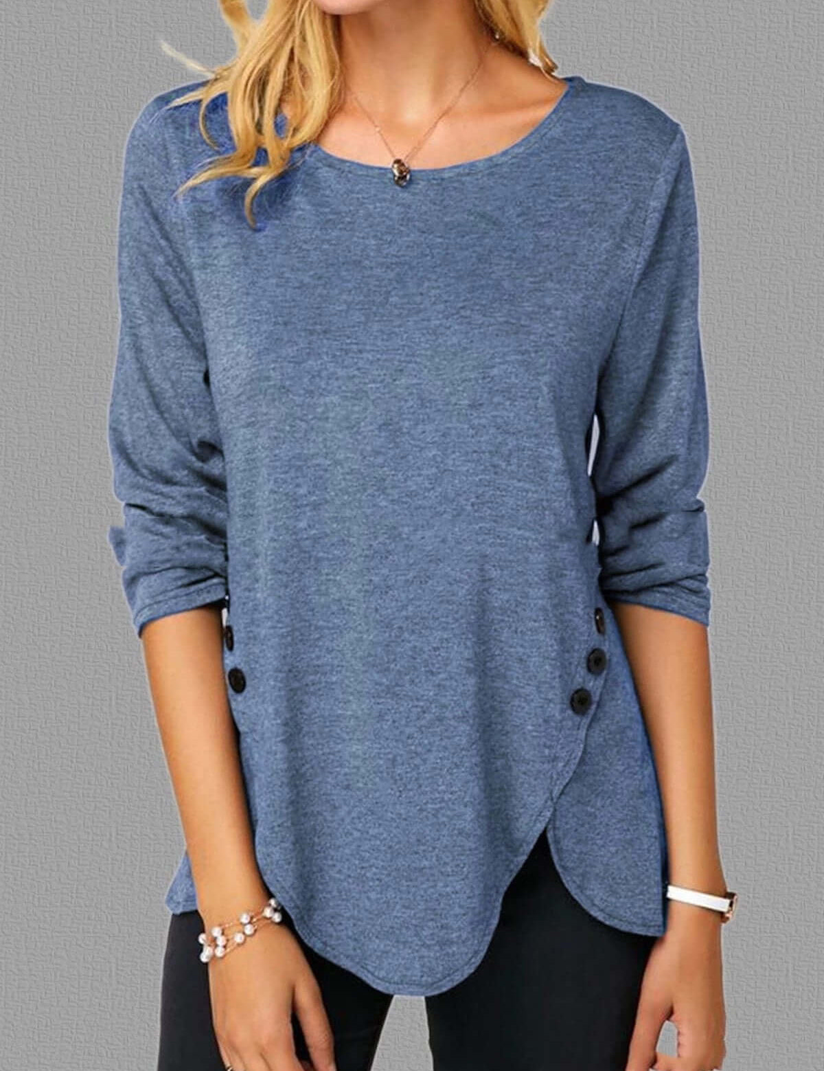 Irregular button hem blue long sleeved round neck oversized T-shirt.