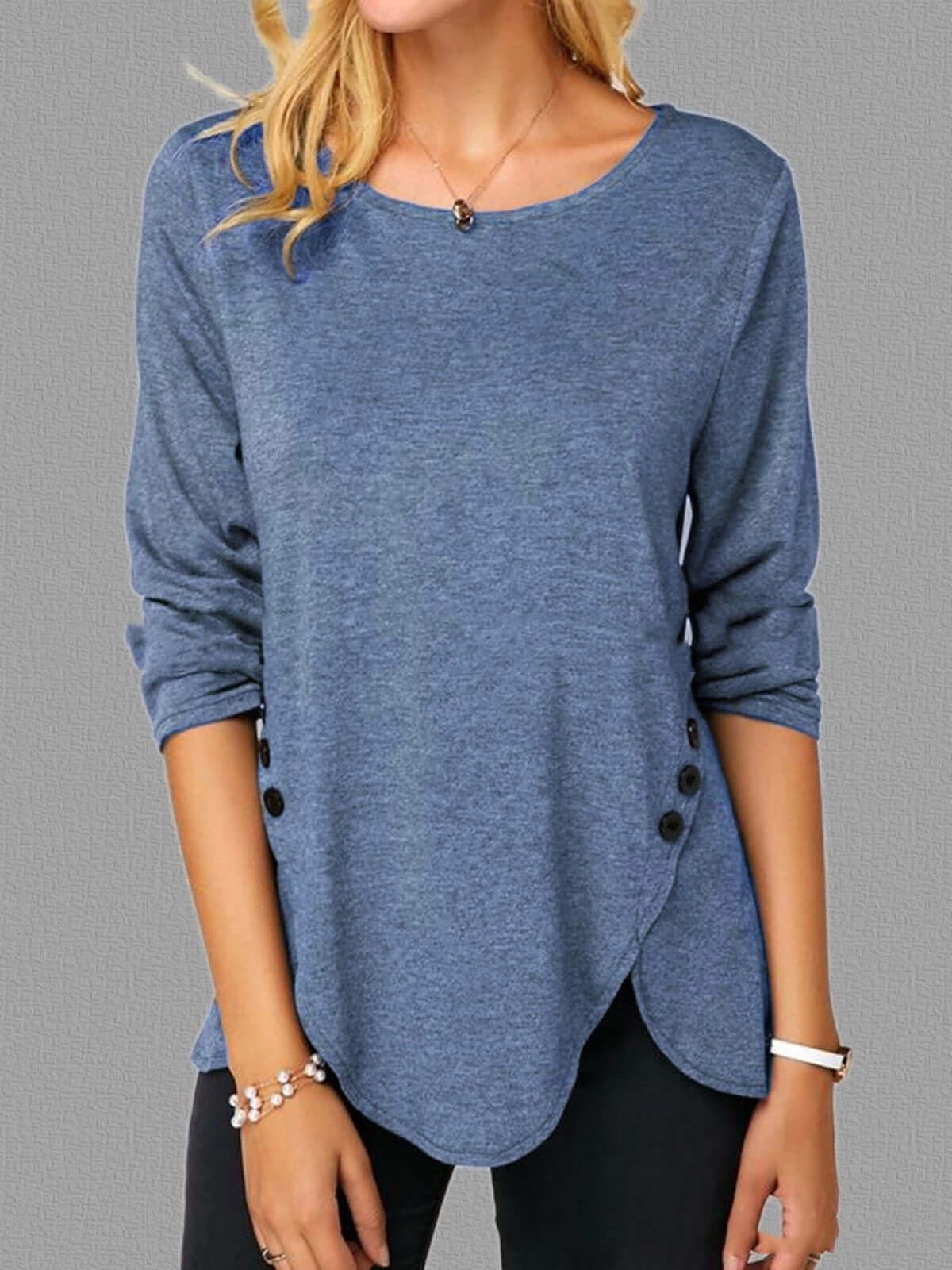 Irregular button hem blue long sleeved round neck oversized T-shirt.