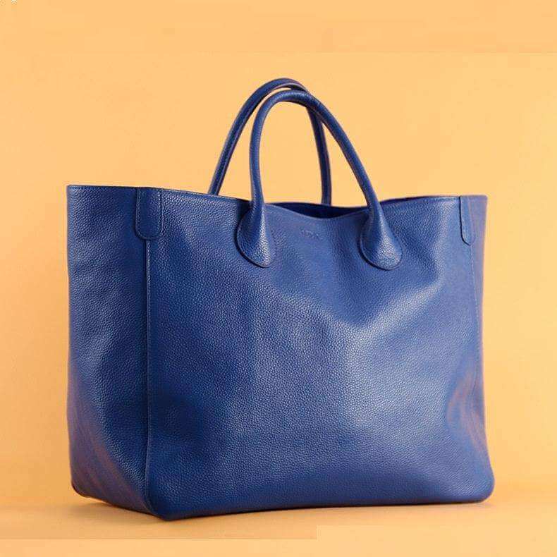 Top layer leather blue hand-held fashionable ladies tote bag.