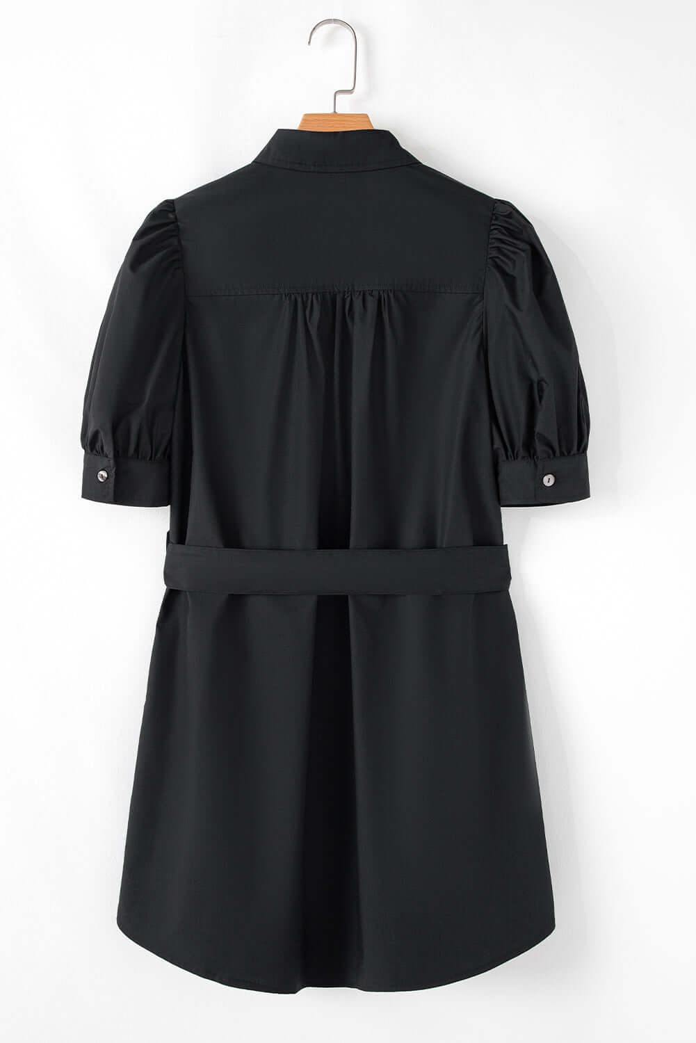 Back view of a black button-up mini dress with puff sleeves and a tie waist detail.