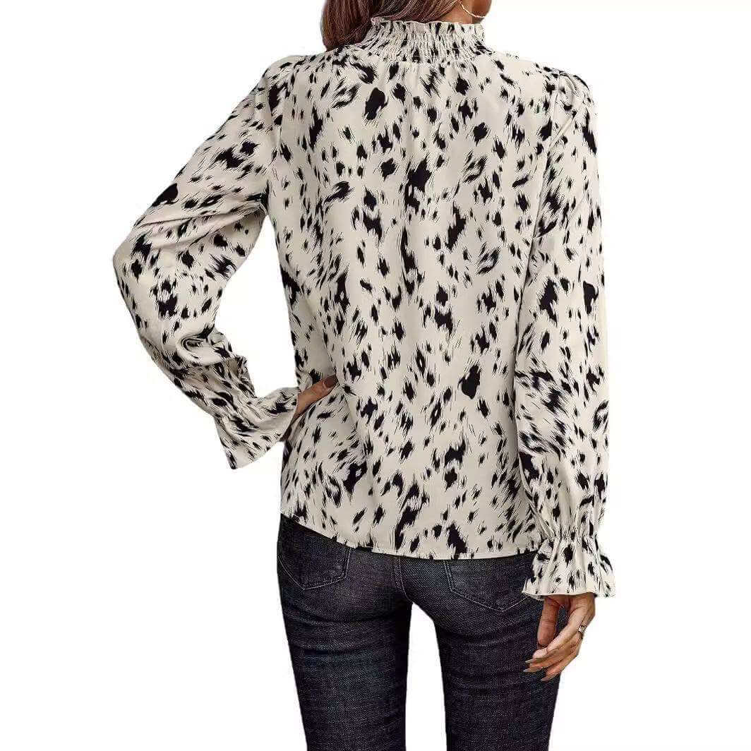 Women's long sleeve turtleneck shirt with black and white pattern.