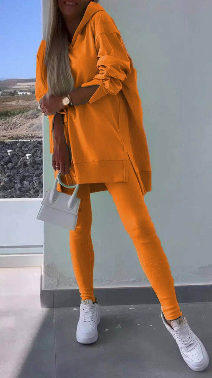 Women's casual hooded sweatshirt and tights set in orange with long sleeves.