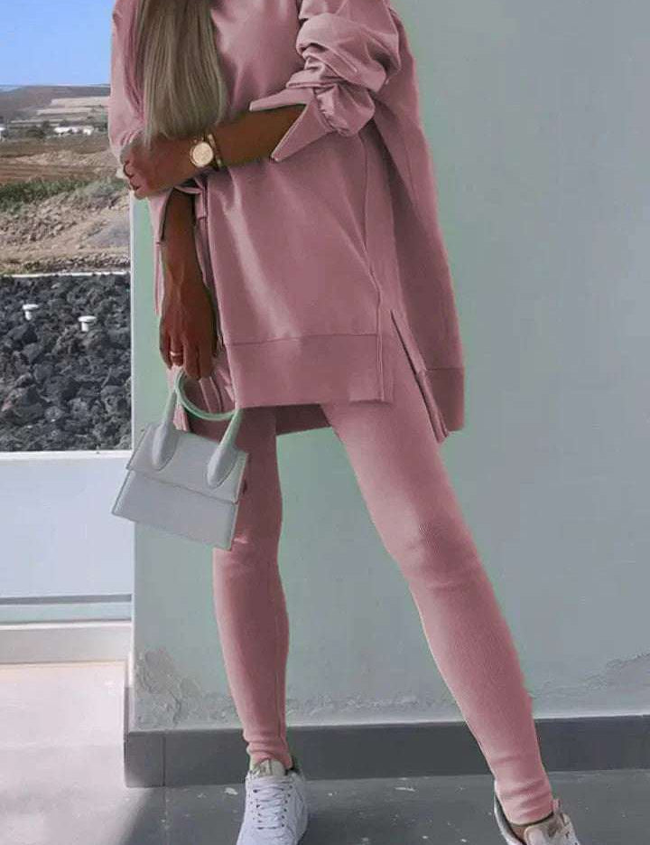 Women's pink hooded sweatshirt and tights set, street fashion style.