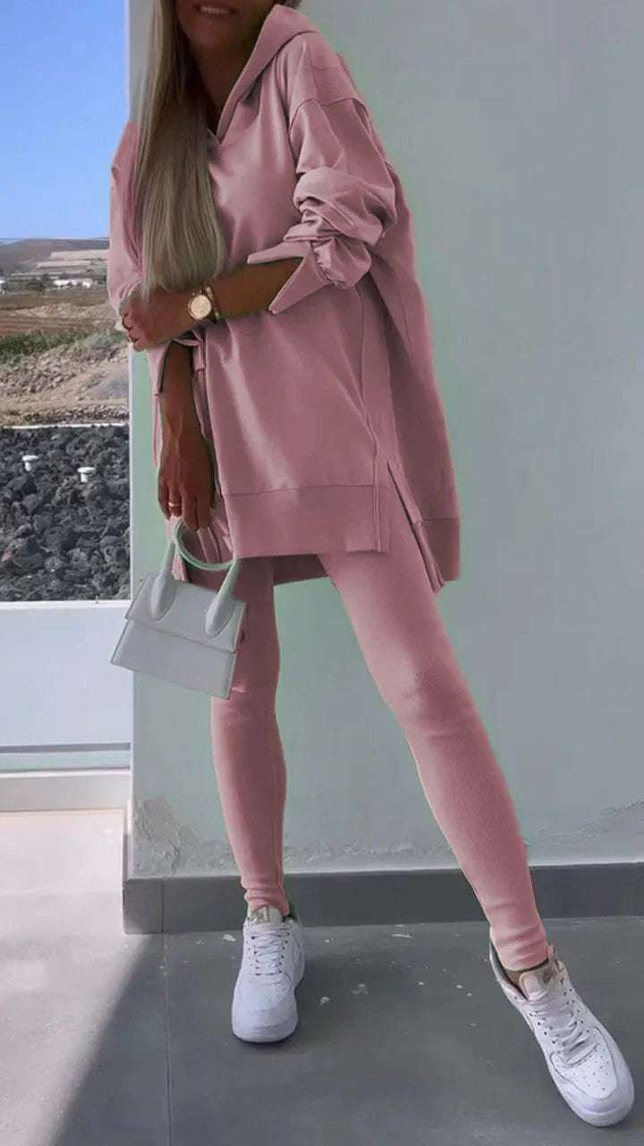 Women's pink hooded sweatshirt and tights set, street fashion style.