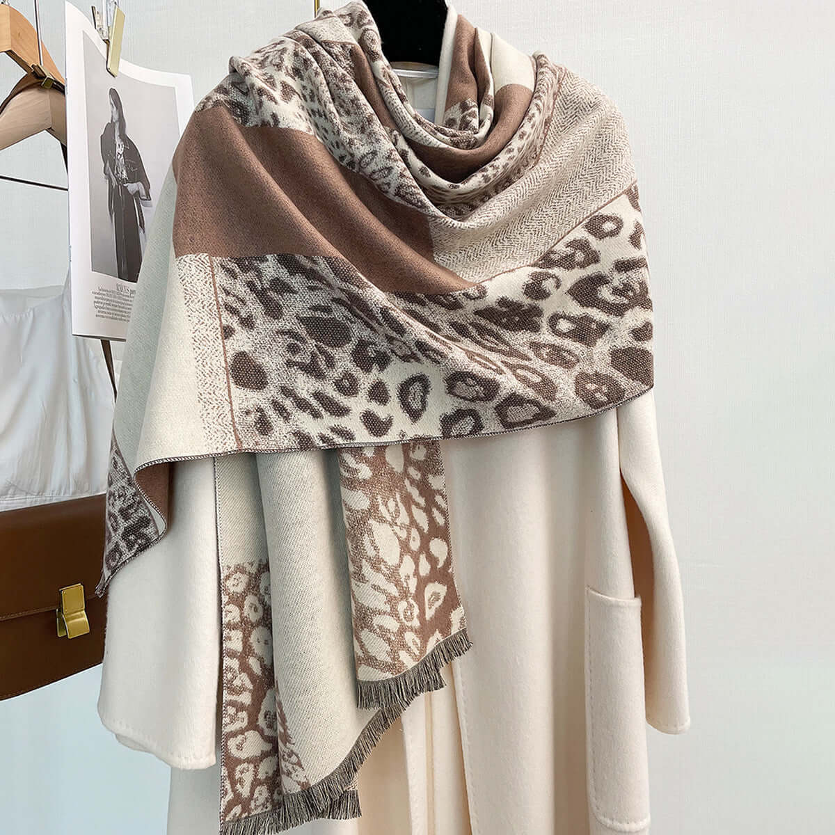 Color-blocking leopard print scarf draped over a white coat, featuring a warm imitation cashmere fabric, perfect for autumn and winter.