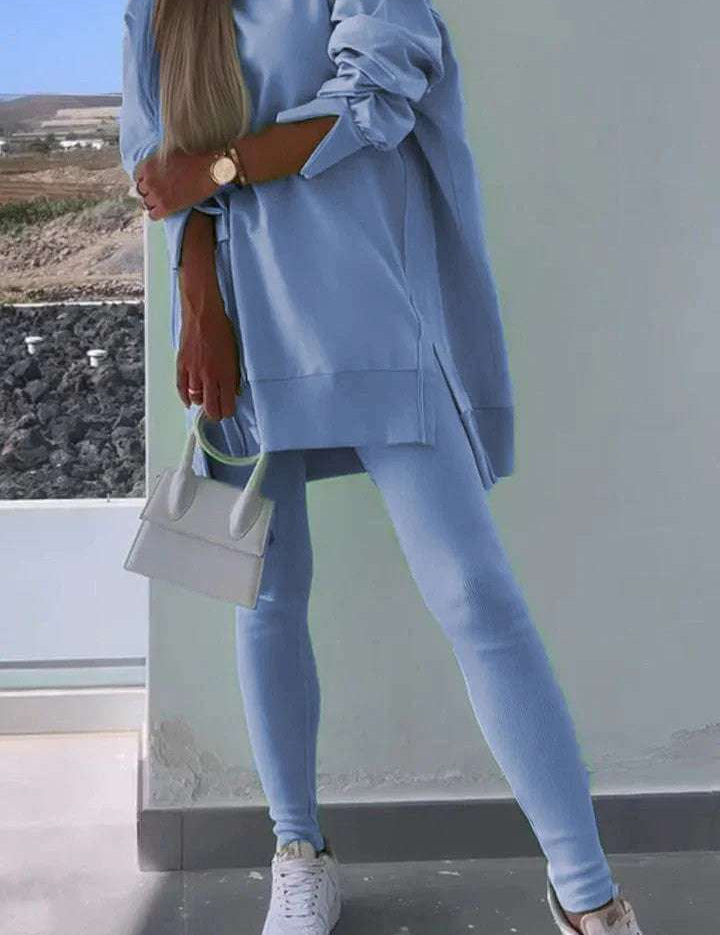 Women's blue hooded sweatshirt and tights set for street fashion.