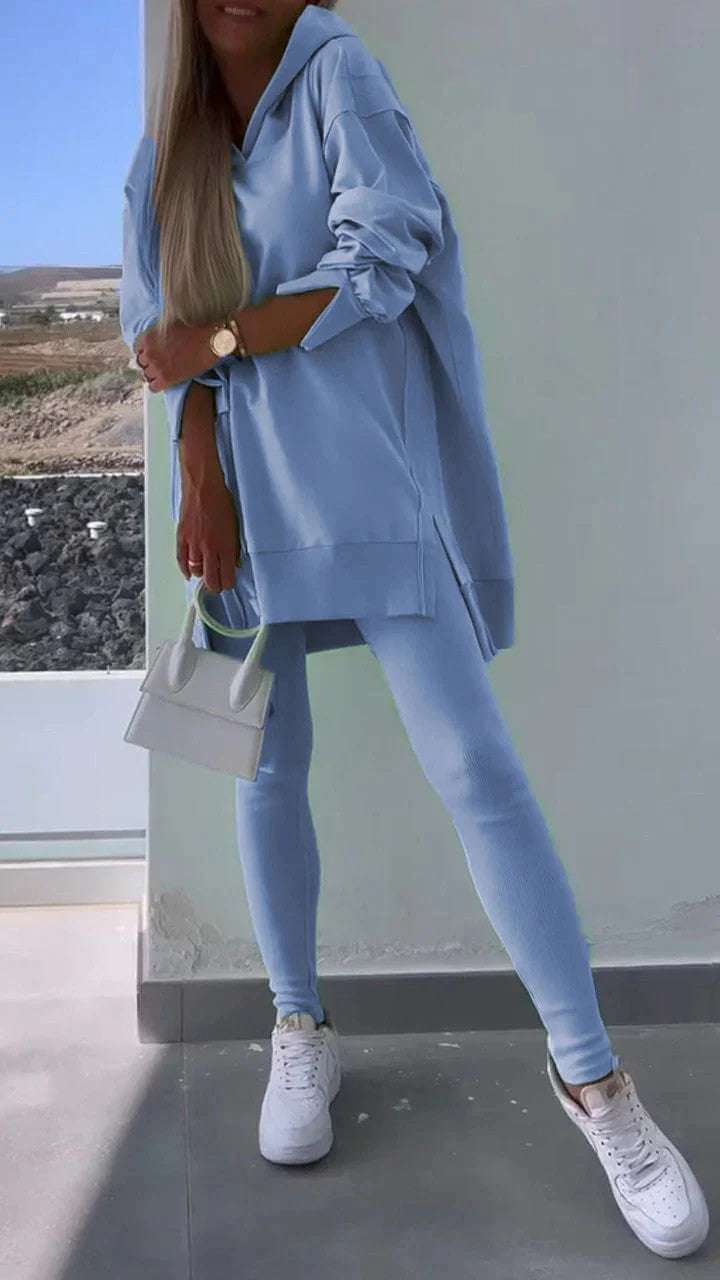 Women's blue hooded sweatshirt and tights set for street fashion.