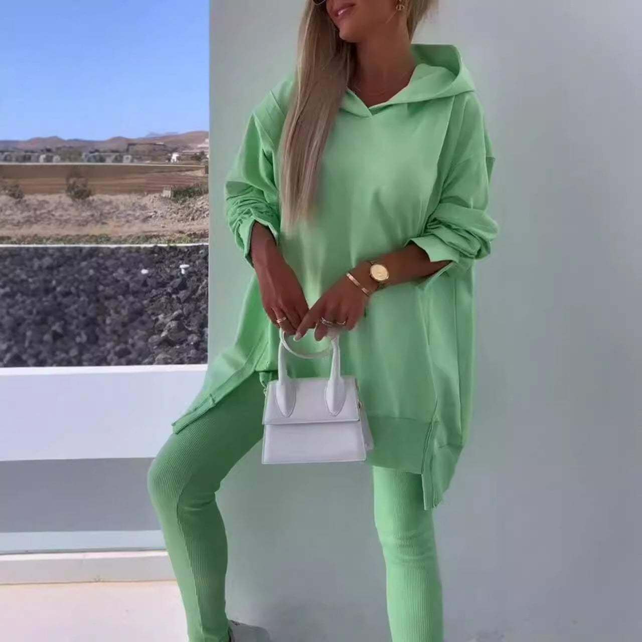 Women's green hooded sweatshirt and tights set, street fashion style.