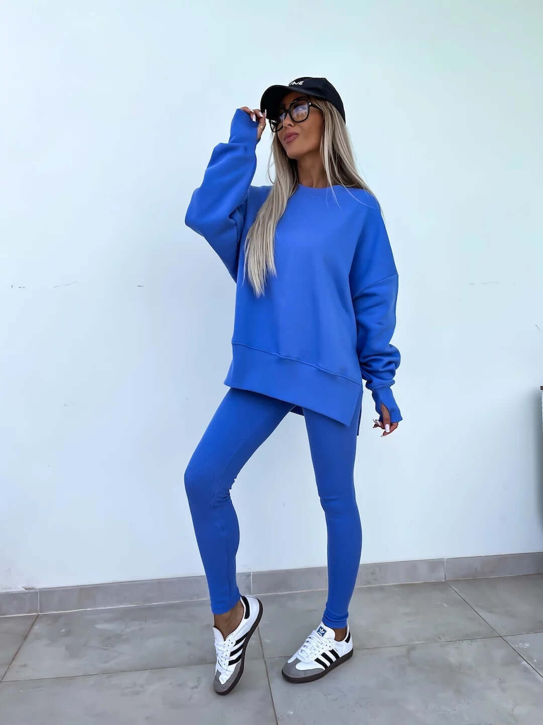 Women's casual loose long sleeve crew neck split top with tight trousers in blue.