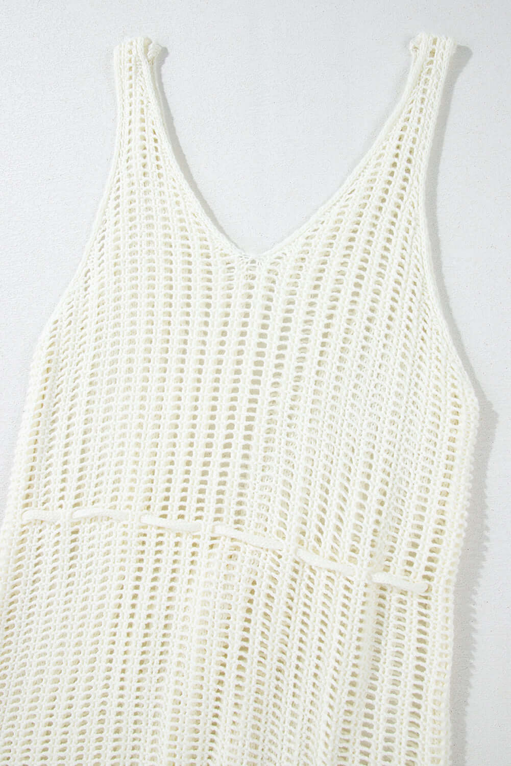 White crochet fishnet beach cover up with v-neck and lightweight design perfect for summer outings.