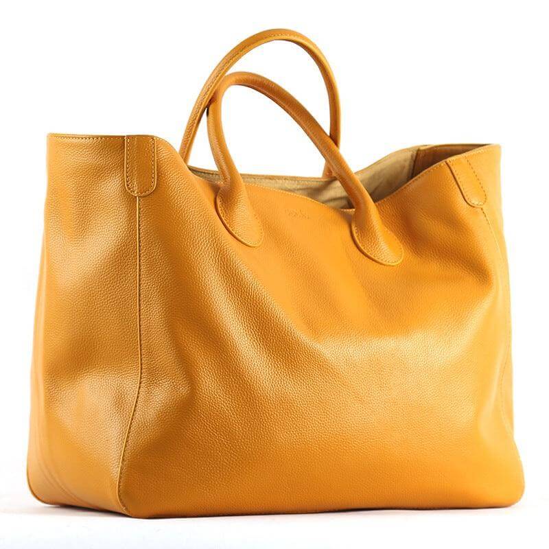 Top layer leather fashionable ladies tote bag in tan color, hand-held design.