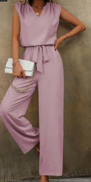 Women solid color sleeveless top with notch neckline and belted long pants set in pink.