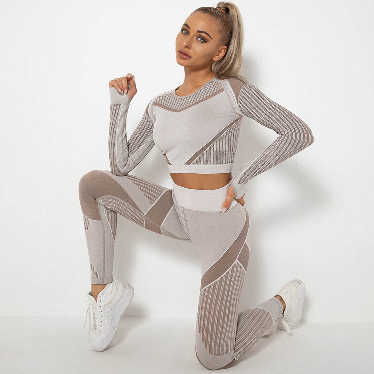 Seamless knitted absorbent yoga long-sleeved suit in striped pattern for women, breathable nylon and spandex fabric.