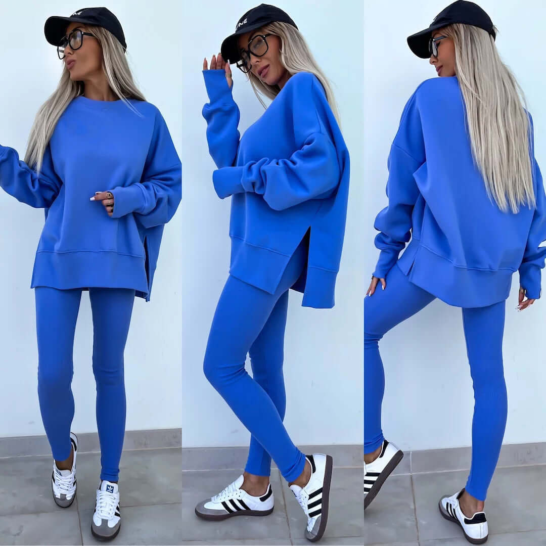 Women's blue casual loose long sleeve crew neck sweater suit with split top and tight trousers.