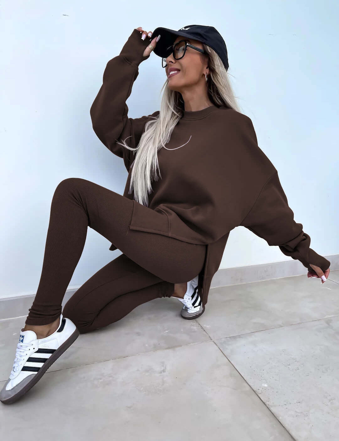 Women's casual loose long sleeve crew neck split top with tight trousers in brown.