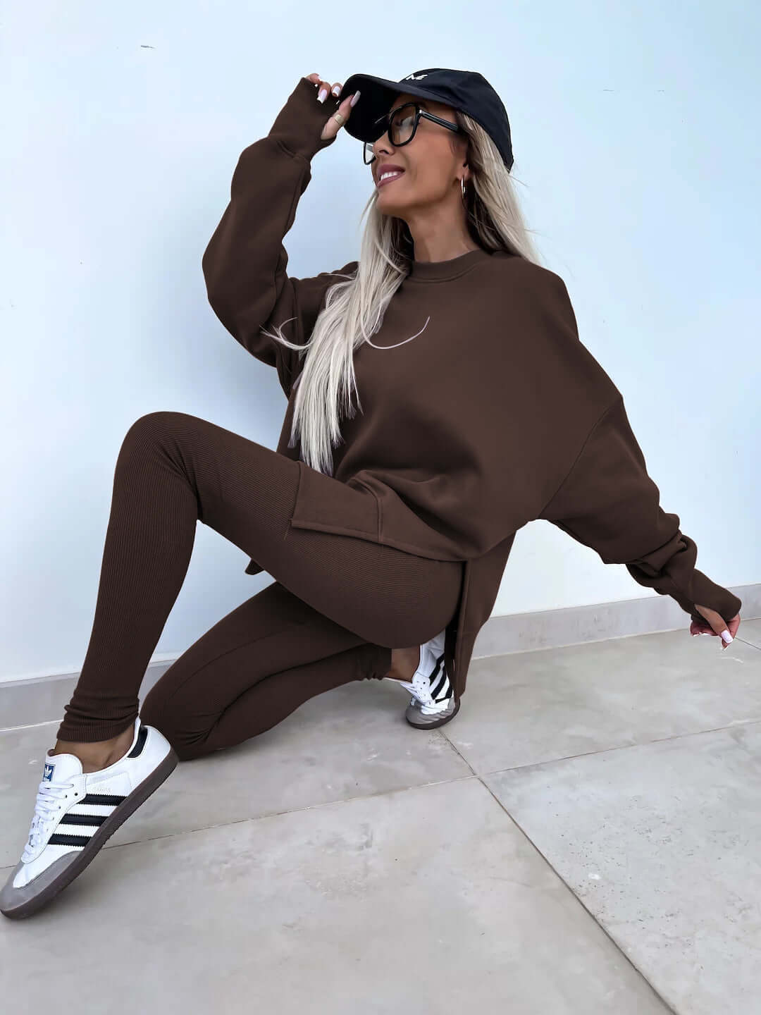 Women's casual loose long sleeve crew neck split top with tight trousers in brown.