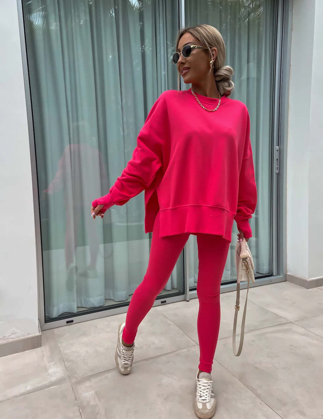 Women's casual loose long sleeve crew neck split top and tight trousers in pink.