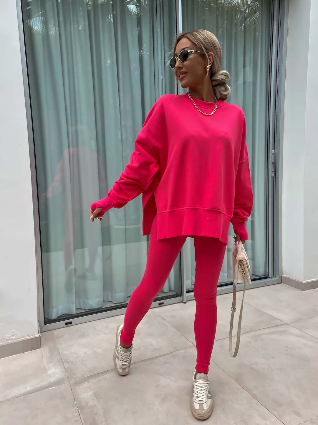 Women's casual loose long sleeve crew neck split top and tight trousers in pink.