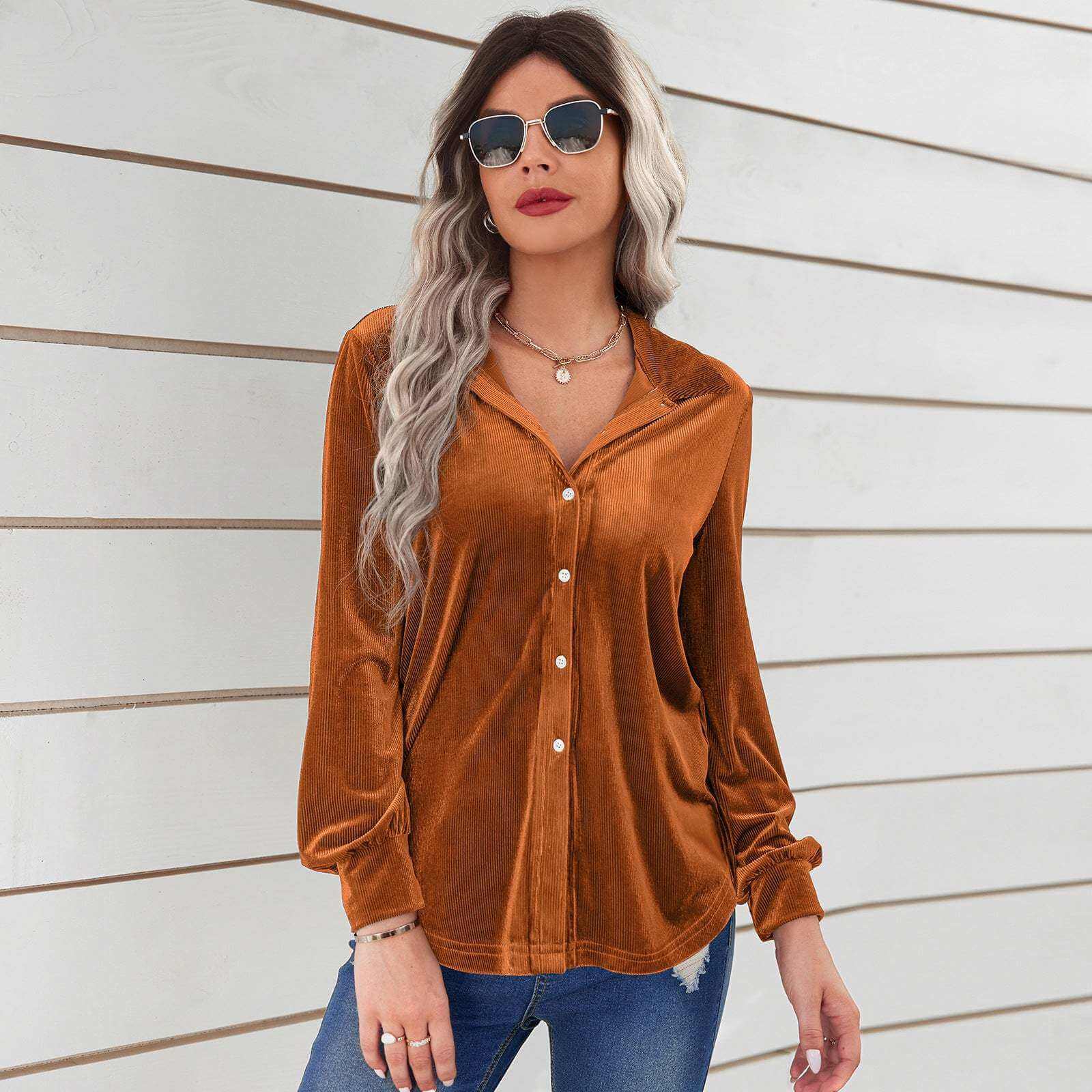 Ladies fashion caramel velvet striped loose shirt with long sleeves and high collar.